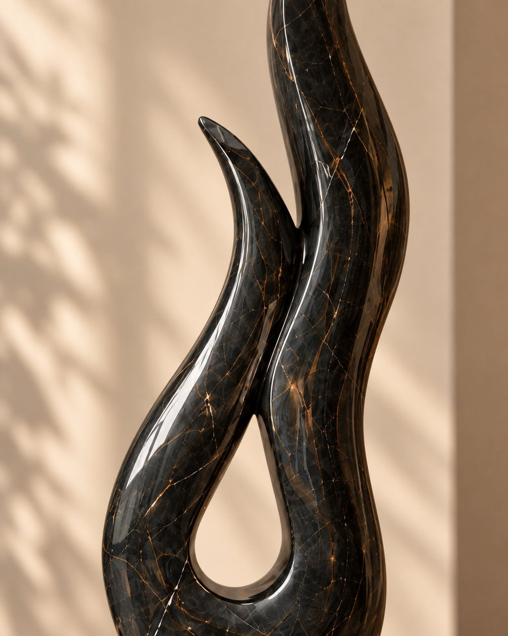 Black marble sculpture on contrasting stone base
