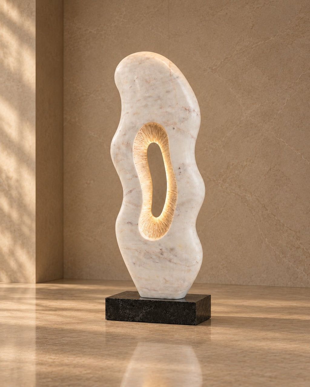Large organic marble sculpture against a lit wall